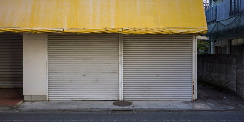 Commercial rolling shutter door showcasing repair and maintenance services for business properties.