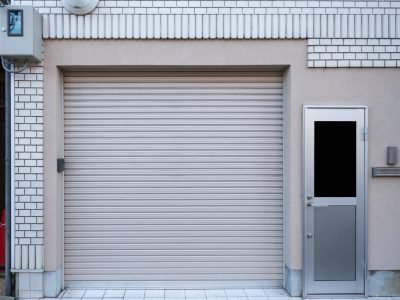 Garage with door residence on white brick in suburb area