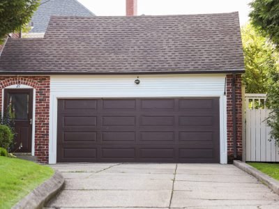 suburban-house-with-white-garage-door-nestled-green-garden-epitomizing-home-security